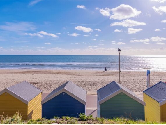 Image of Beach Huts in front of the sand